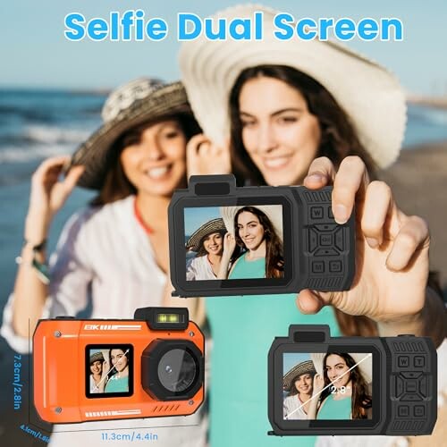 Two women taking a selfie on the beach using a dual screen camera.