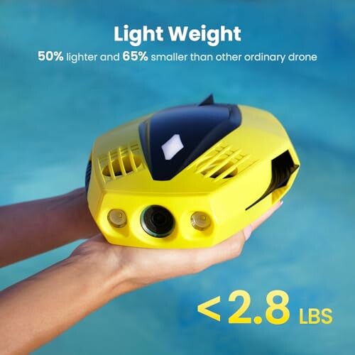 Yellow underwater drone held over water, highlighting lightweight design.